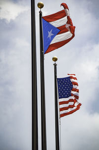 Low angle view of flag flags against sky