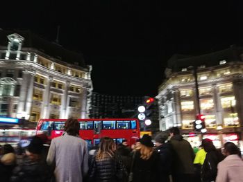 Crowd on illuminated city at night