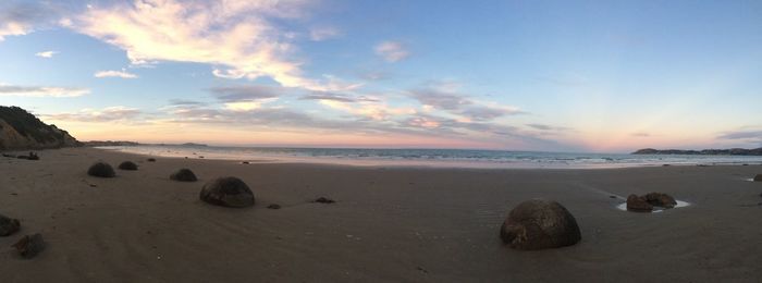 Scenic view of beach against sky during sunset