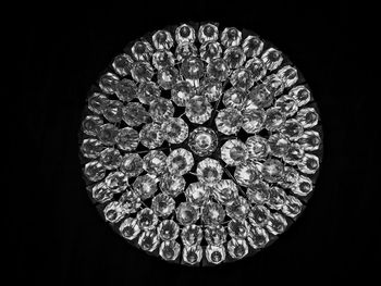 Directly below shot of illuminated pendant light against black background