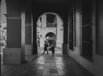 People walking in corridor of building