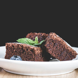 Close-up of cake on plate against black background