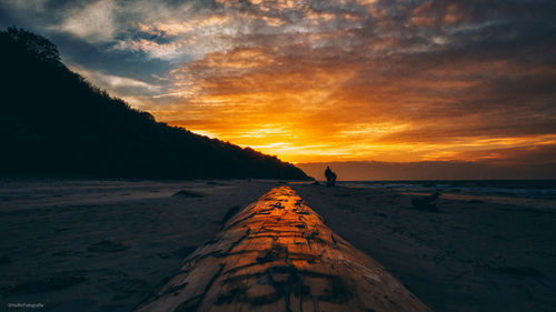 Scenic view of beach against sky during sunset