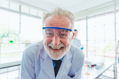 Portrait of man wearing protective eyewear in laboratory