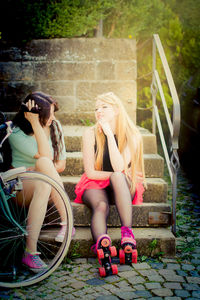 Young women sitting on step