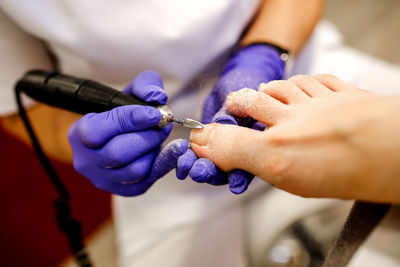 Midsection of doctor treating patient in hospital