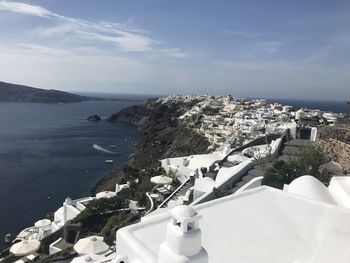 High angle view of buildings by sea against sky