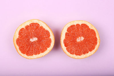 Close-up of orange slices against white background