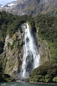 Scenic view of waterfall against sky