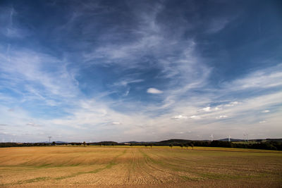 Scenic view of agricultural field against sky