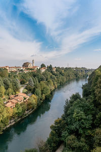 River amidst buildings against sky