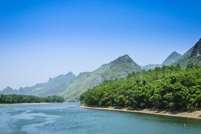 Scenic view of mountains against clear blue sky