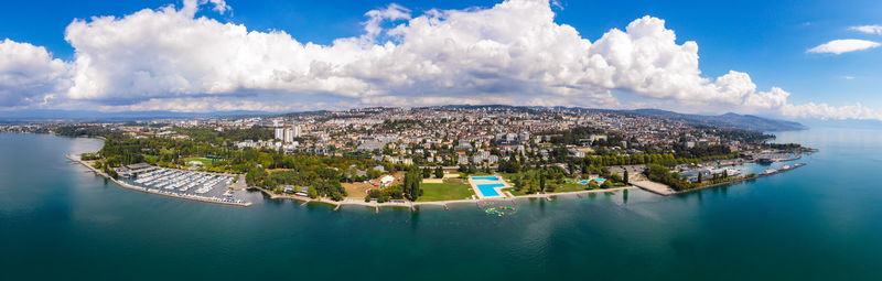 Panoramic view of sea and city against sky