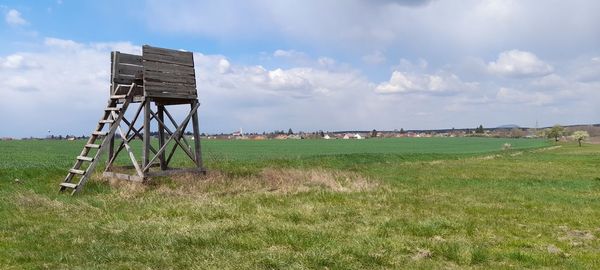 Built structure on field against sky