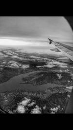 Aerial view of airplane wing over landscape