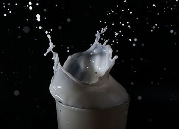 Close-up of ice cubes in water against black background