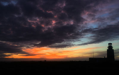 Silhouette of trees against dramatic sky