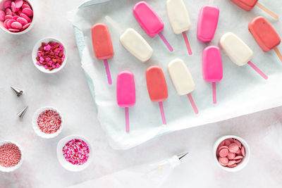 Candy coated cakesicles ready for decorating with sprinkles.