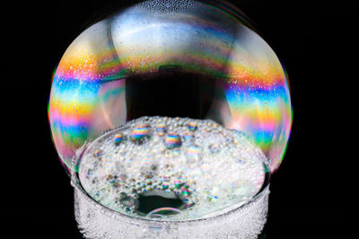 Close-up of bubbles against black background