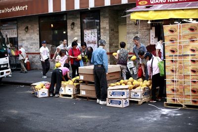 People buying fruits at street market