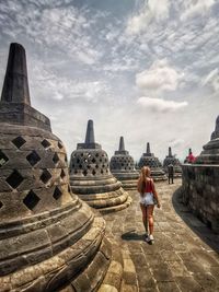 Tourists at temple against building