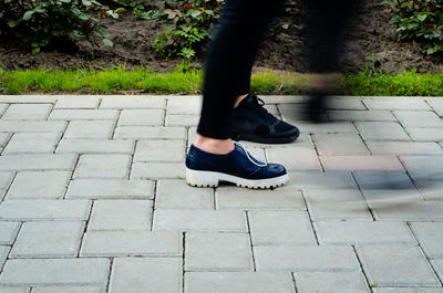 Low section of man walking on footpath