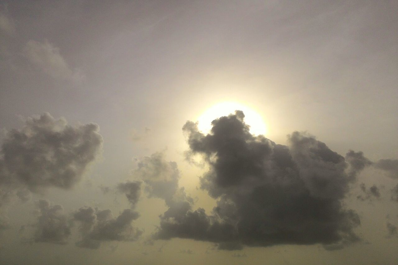 sky, sunset, cloud - sky, scenics, sun, beauty in nature, tranquility, tranquil scene, low angle view, nature, sunbeam, idyllic, sunlight, cloud, sky only, cloudy, outdoors, cloudscape, no people, silhouette