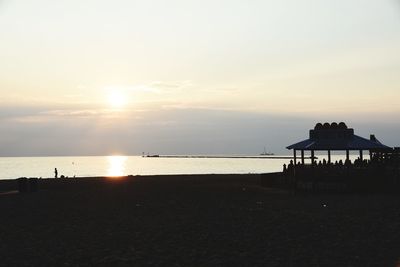 Scenic view of beach against sky during sunset