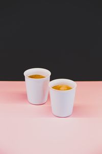 Close-up of coffee cup on table against black background