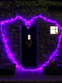 Illuminated purple wall at night