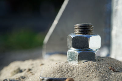 Close-up of rusty metal on sand