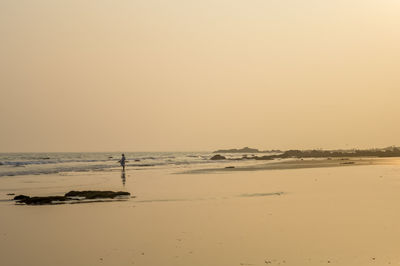 Scenic view of beach against sky during sunset