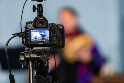 Close-up of camera with women in background