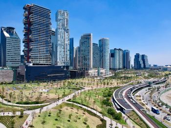 Aerial view of city buildings against clear sky