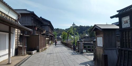 Footpath amidst buildings against sky