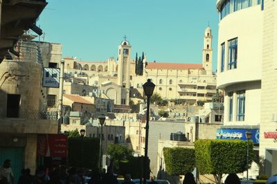 Panoramic view of people in city against clear sky