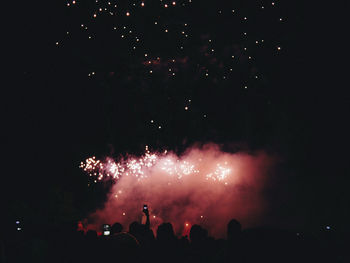 Low angle view of firework display at night