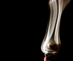 Close-up of wineglass against black background