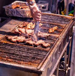 Man preparing food on barbecue grill