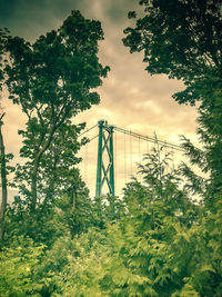 View of suspension bridge against cloudy sky