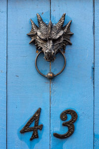 House number 43 under a dragon head door knocker 