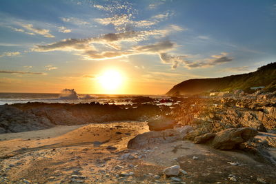 Scenic view of beach against sky during sunset