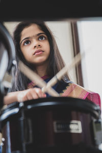 Girl in sari playing drum