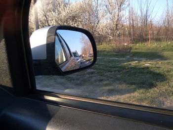 Reflection of car on side-view mirror