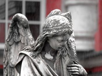 Weathered statue of angel 