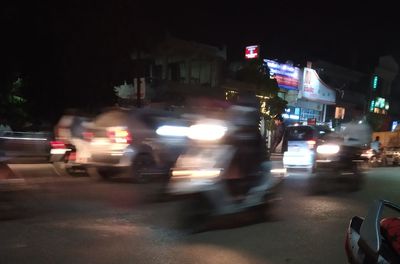 Cars on city street at night