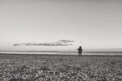 Man standing on field against sky