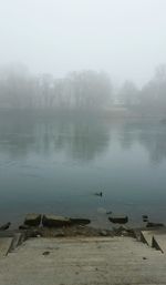 Scenic view of lake during foggy weather