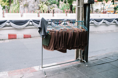 Close-up of clothes hanging on built structure