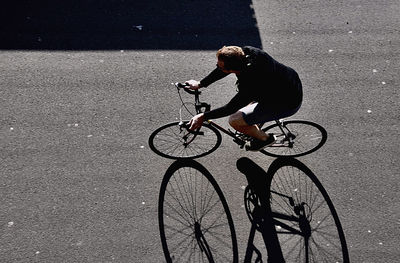 Man riding bicycle on street in city